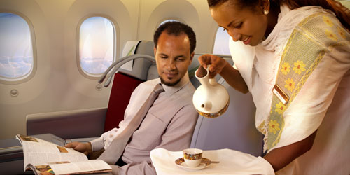 Ethiopian airlines cabin crew  fetching coffee for a passenger